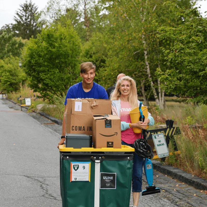 Student and parent pushing move-in cart