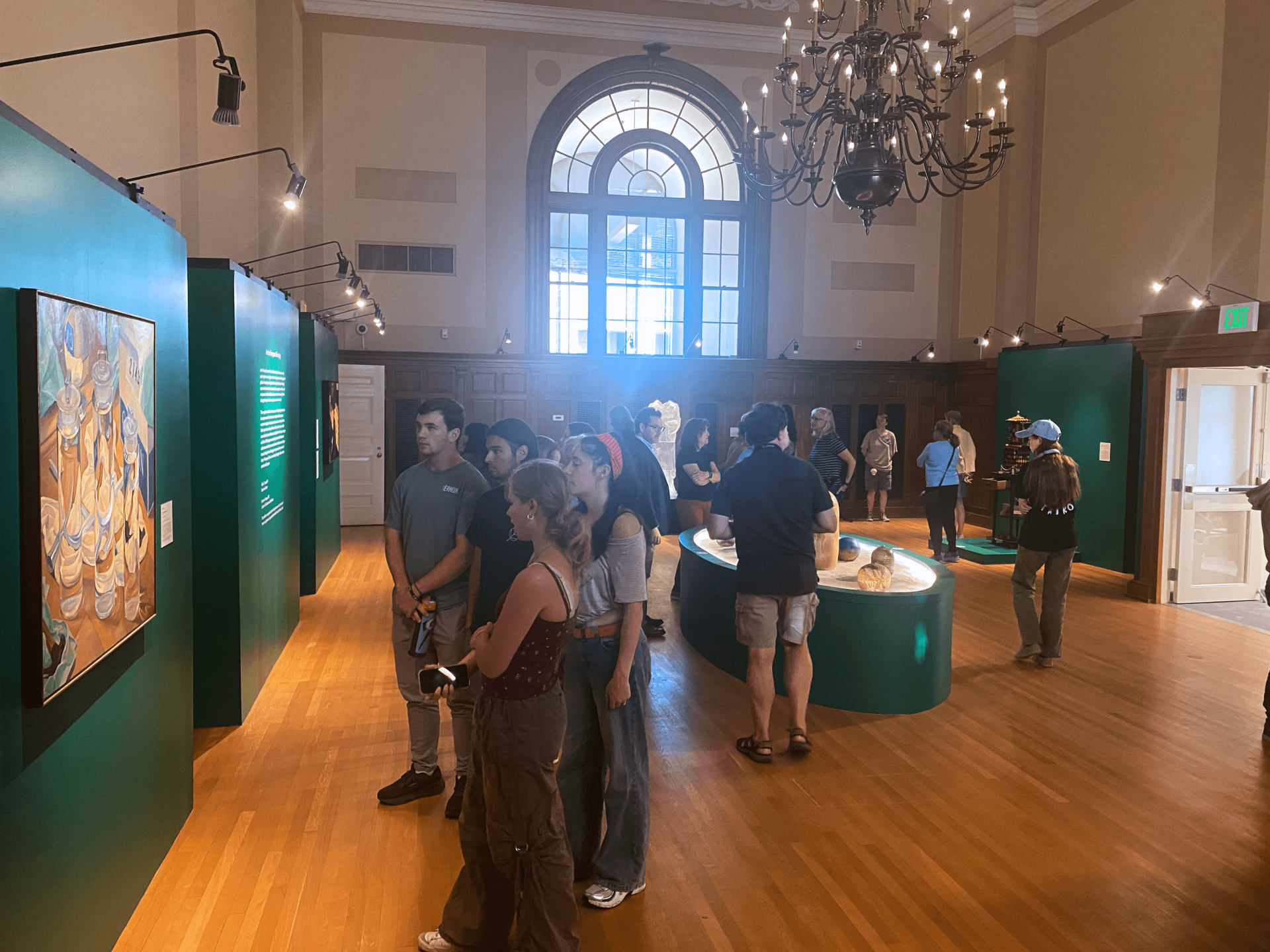 Visitors in the Fleming's 'Belonging' gallery discuss the art on view.