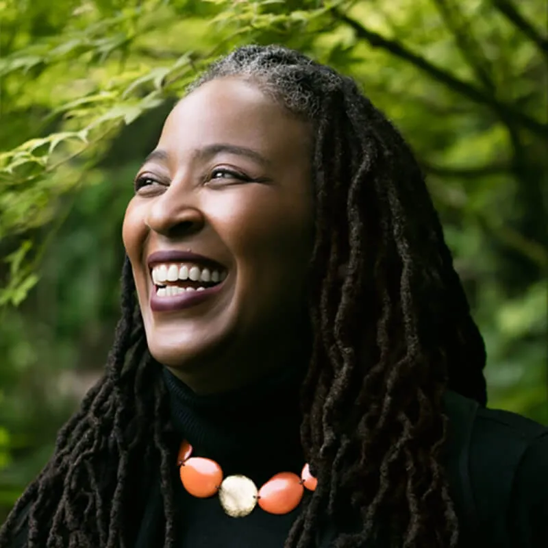 Author Camille T. Dungy smiling outdoors.