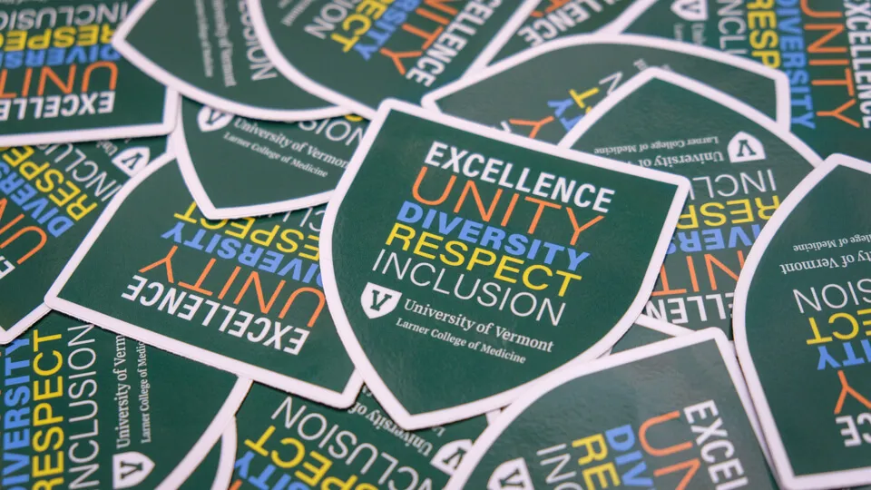 pile of stickers saying excellence unity diversity respect inclusion