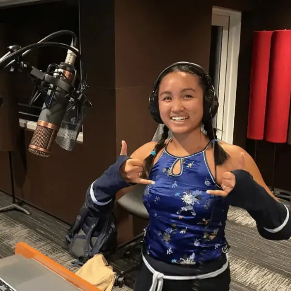 Voice actor Merk Nguyen in a recording studio.