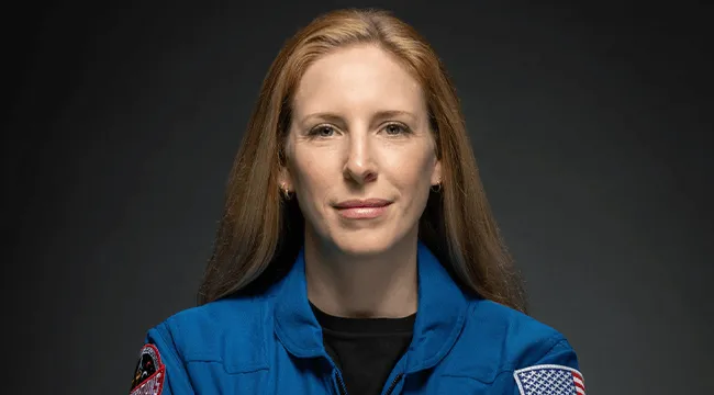 a person in a NASA-branded coverall