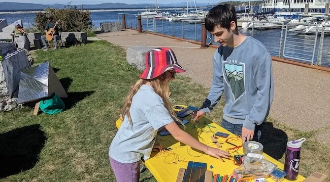 a child and a man stading on either side of a table