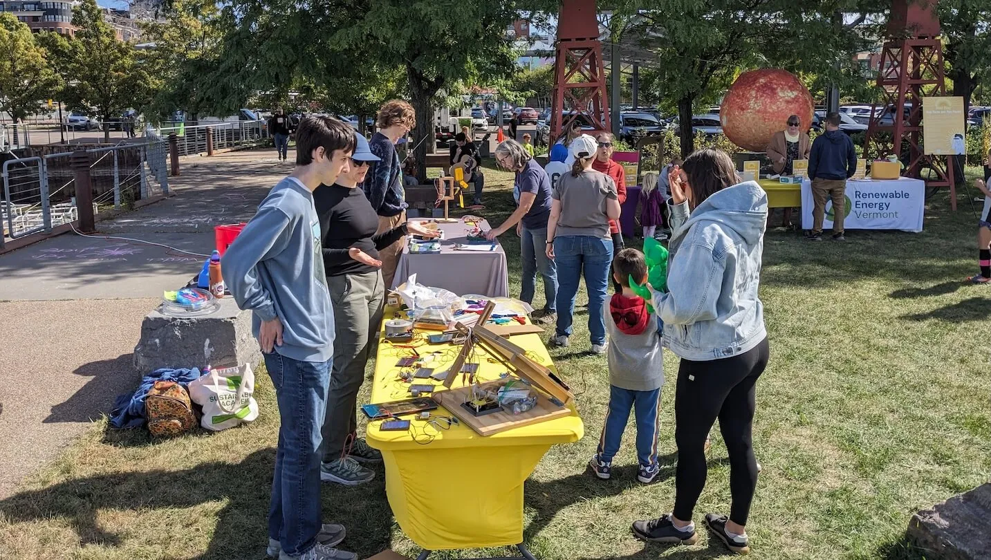 people standing by a table in a park