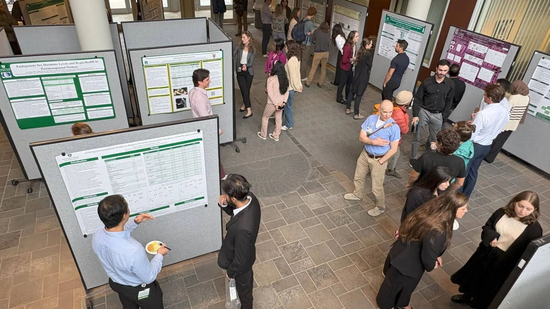 people exploring a research poster display