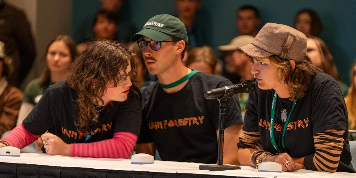 Three of the team members discussing how to answer a question during the competition