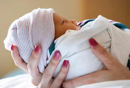newborn being held