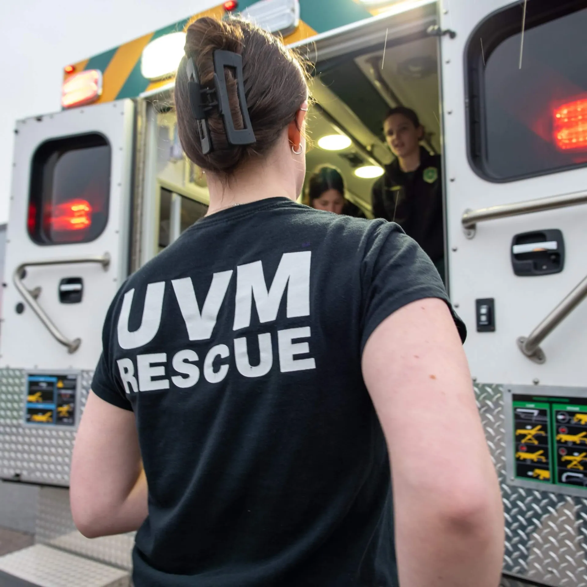 EMT with UVM Rescue enters back of ambulance