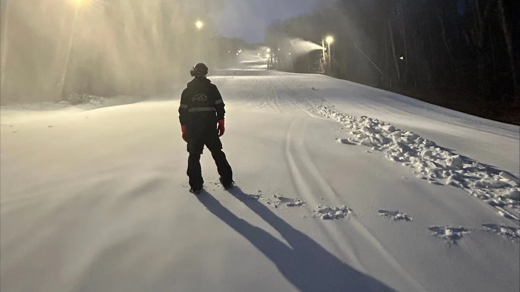 Leo standing on a snowy mountain at night.