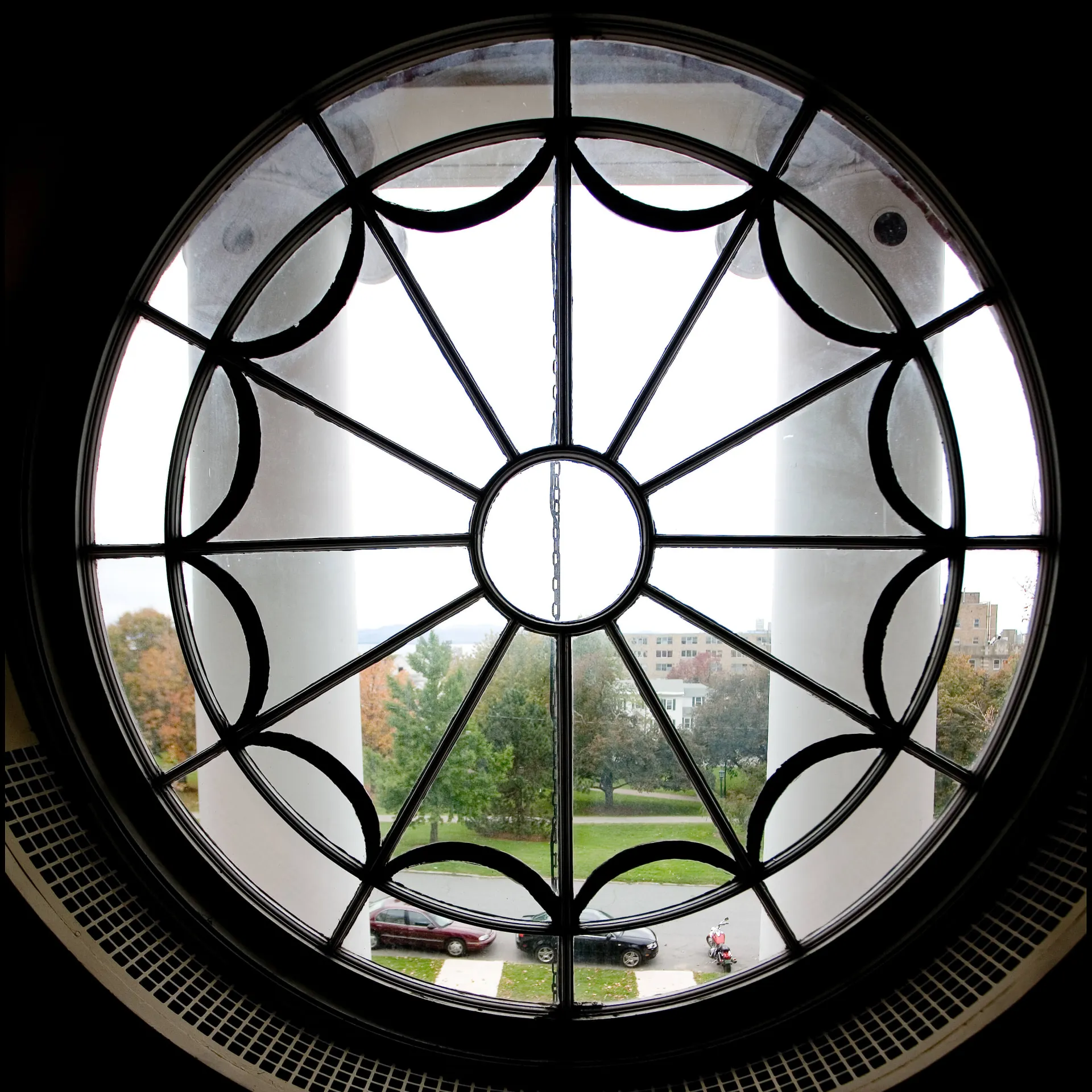 View of greenspace through a circular decorative window