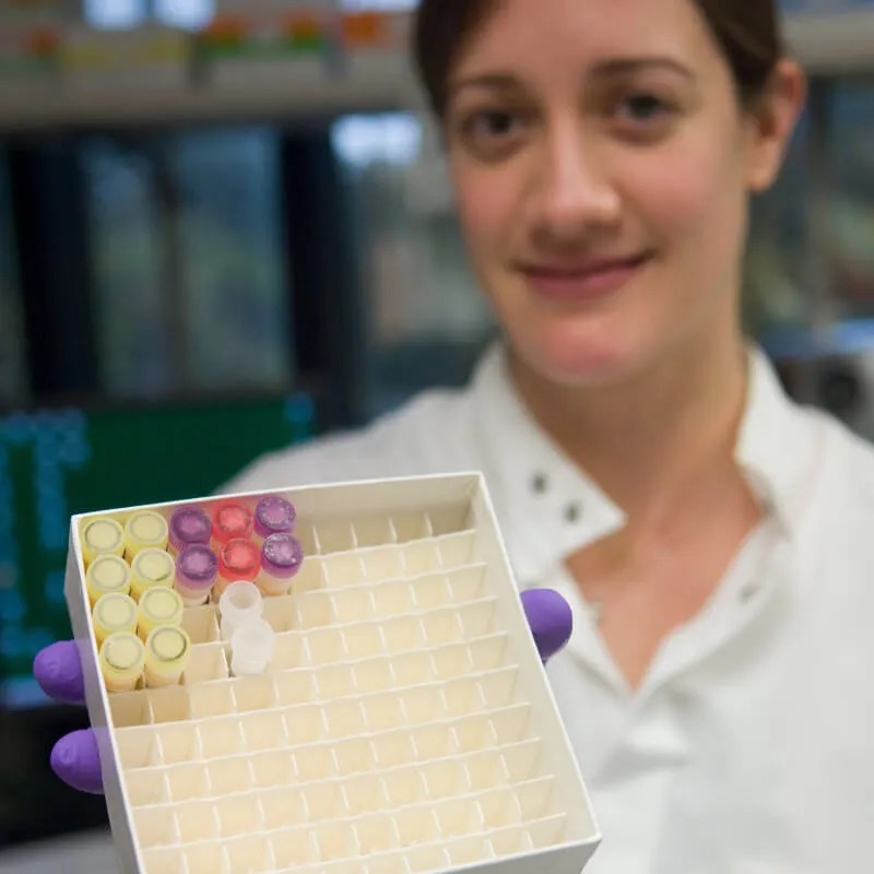 young person holding a container of sealed vials