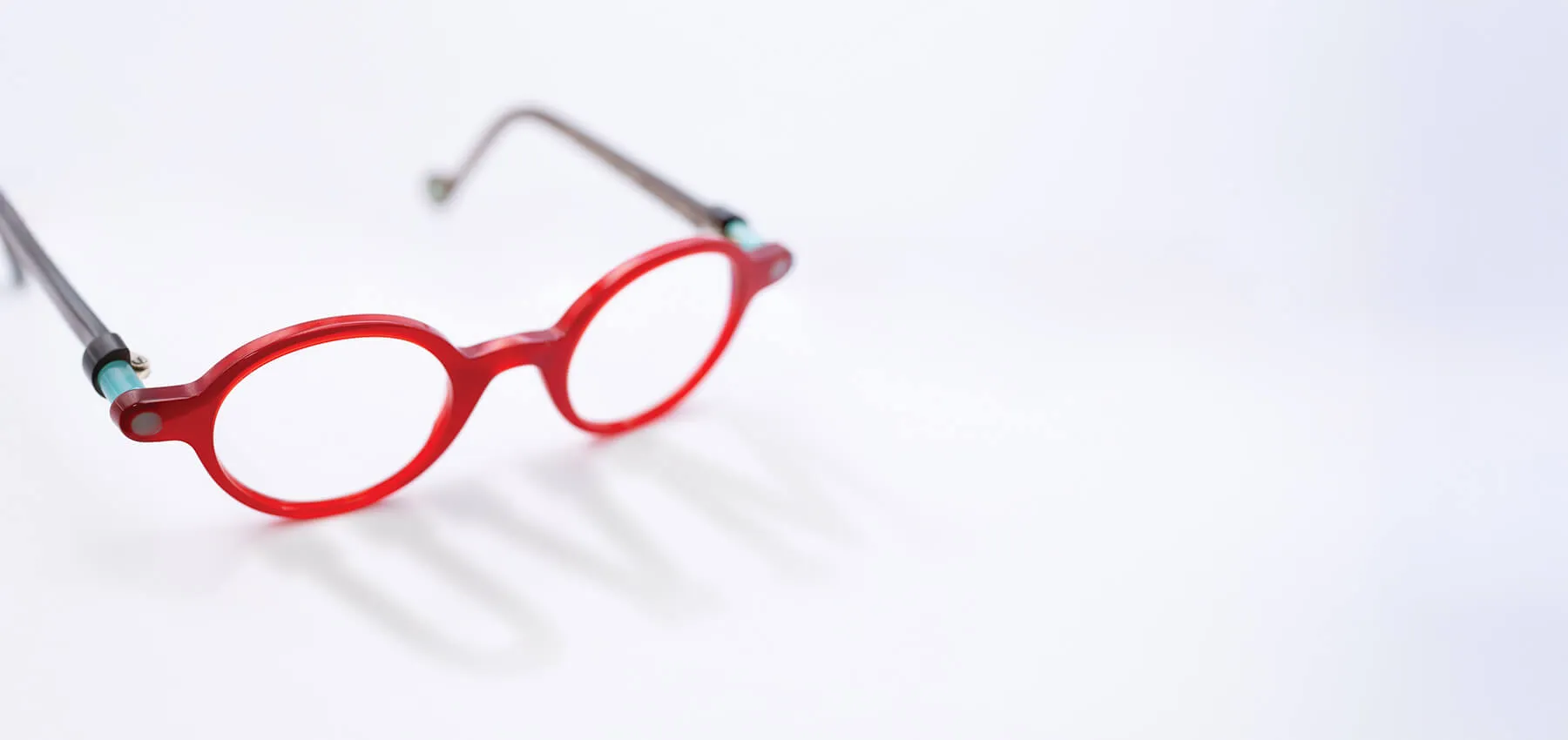 red glasses casting a shadow that says UVM