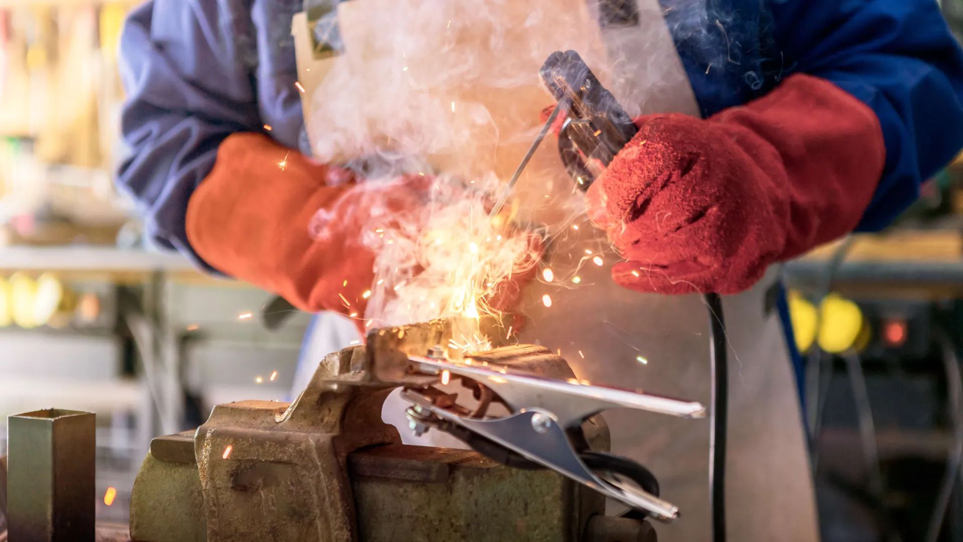 metal worker working with arc welding machine