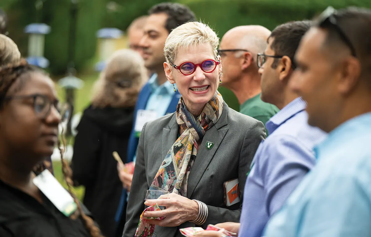 marlene talks with faculty in a group