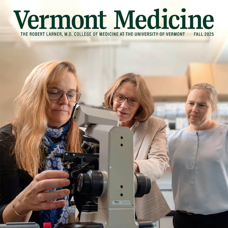 cover of magazine with three researchers looking into microscope