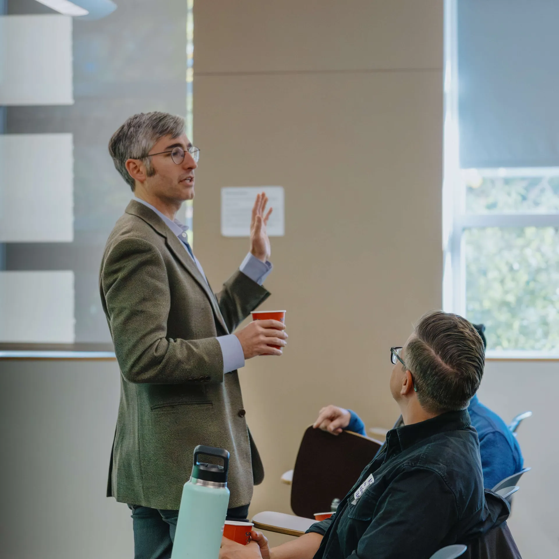 Man speaking with hand up