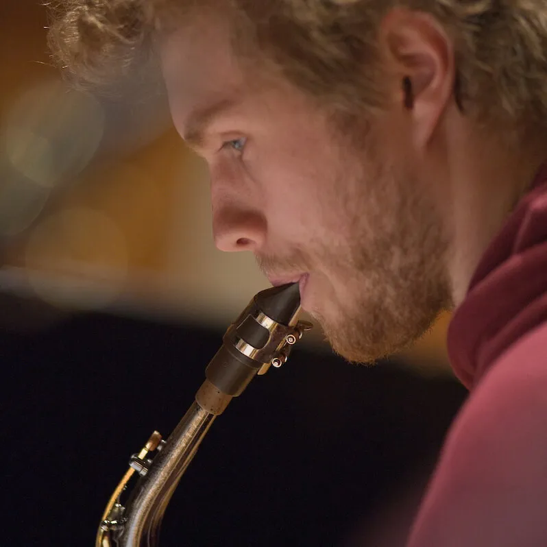 Person playing a saxophone.