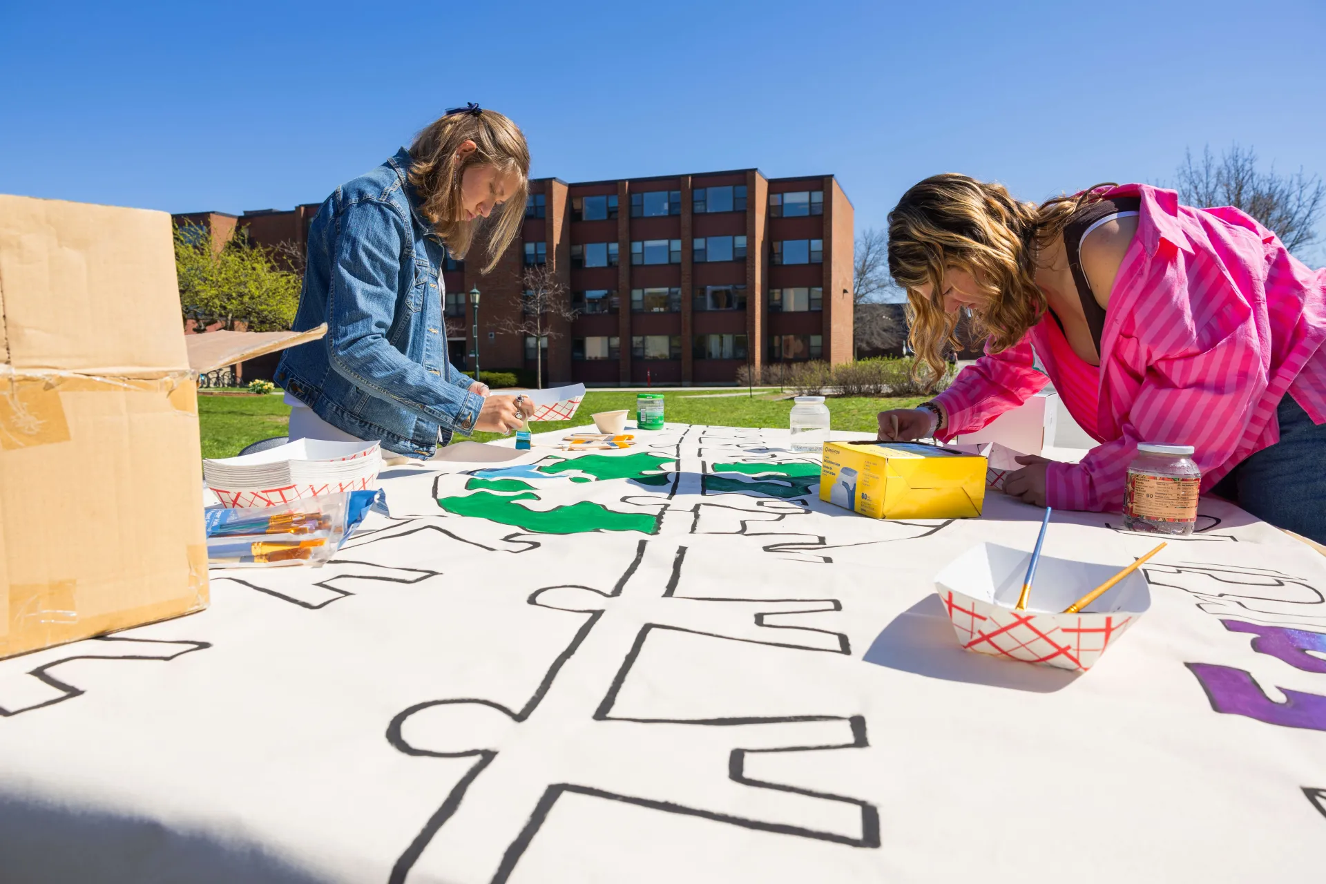Students painting at community event