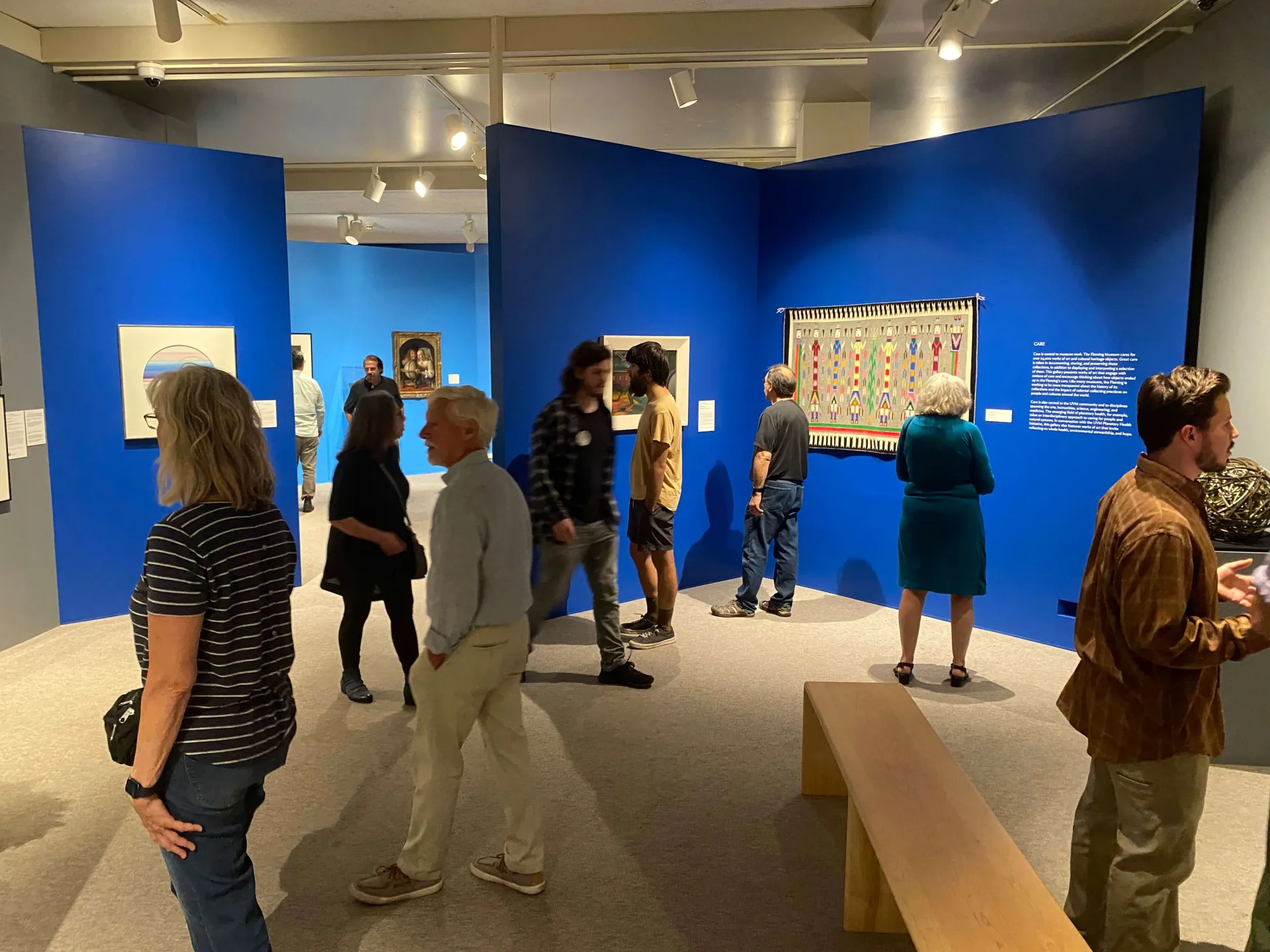 Various visitors in a bright blue gallery