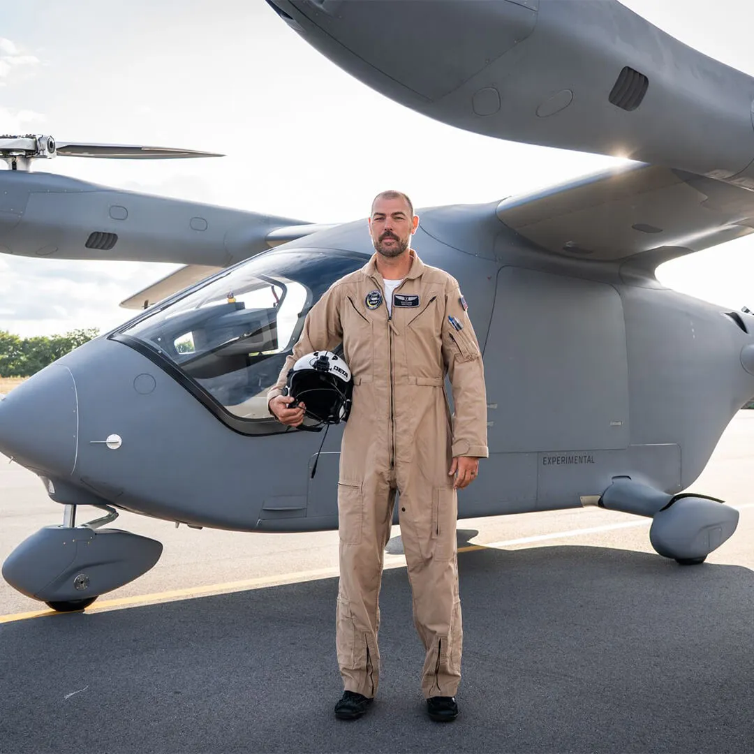 Kyle Clark standing in front of a BETA technologies plane