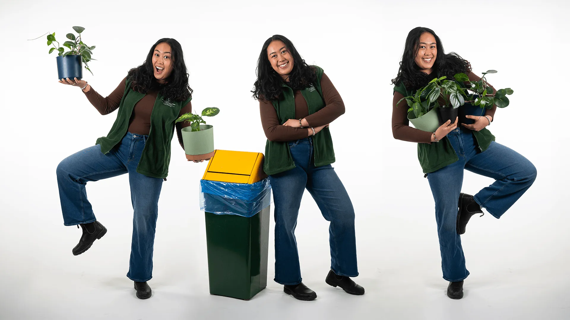 three people two holding plants and one standing next to a green and gold recycling bin