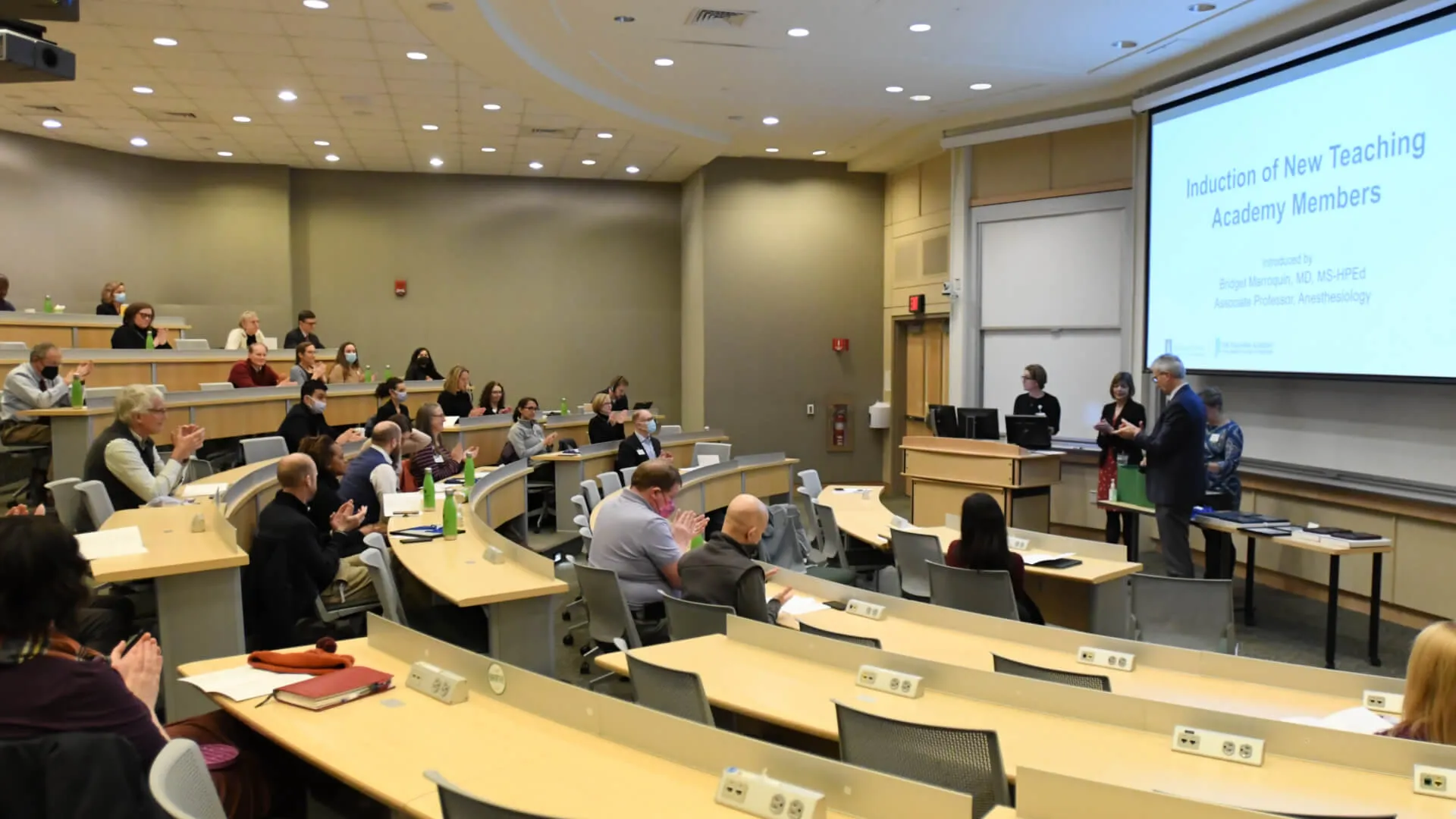 group of people in an auditorium lecture