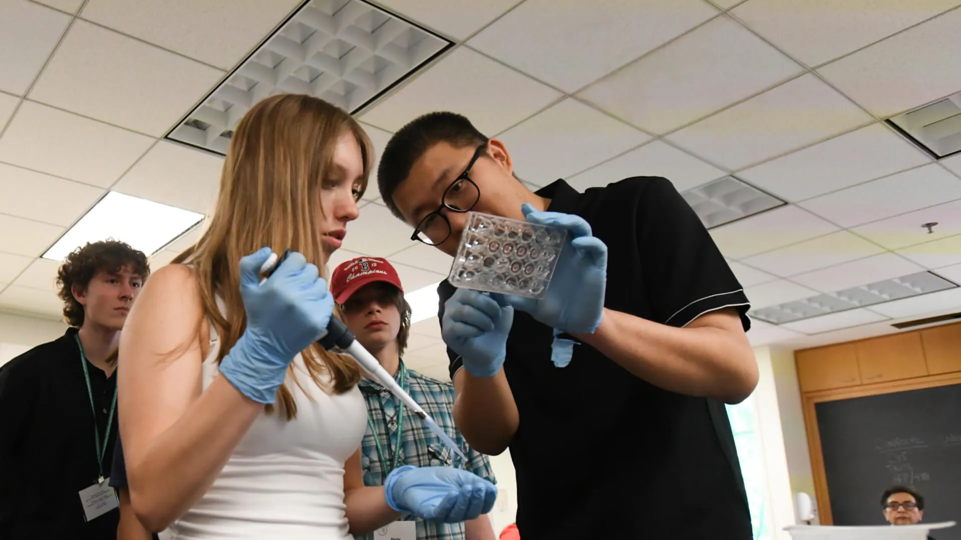 three young students learning lab techniques
