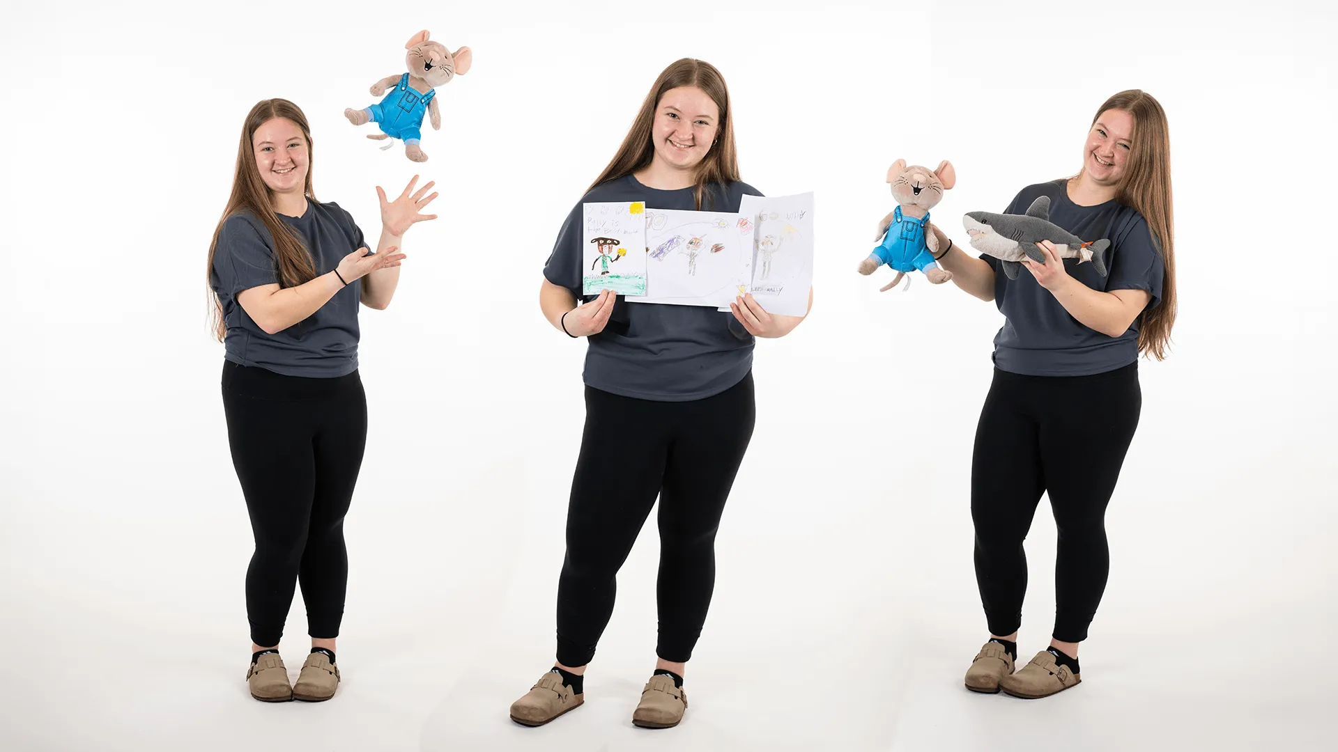 three individuals one holding two stuffed animals, one tossing the stuffed animal in the air, and another holding childrens drawings