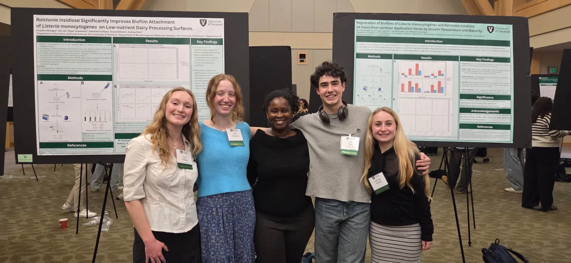 5 students in front of science poster presentation boards