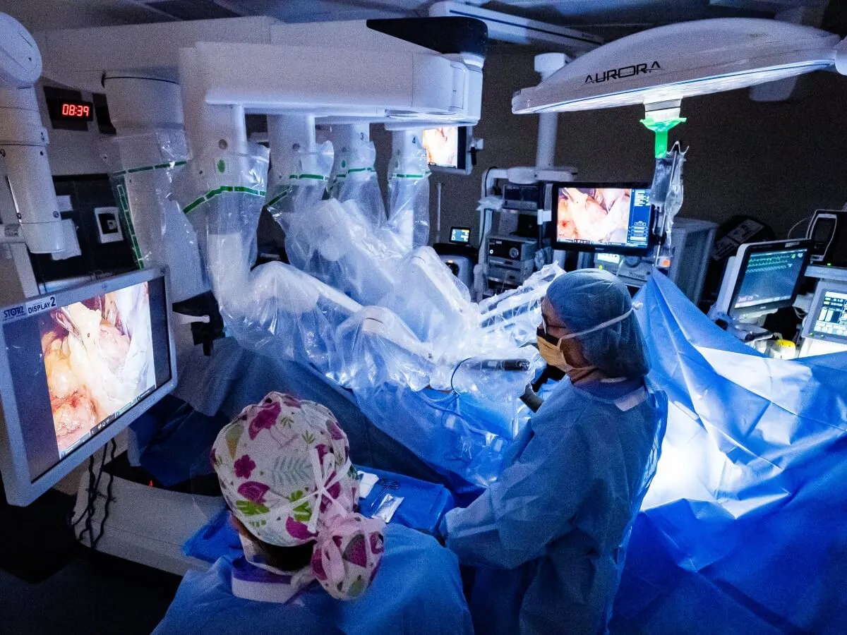Two people in full scrubs looking at a screen displaying endoscopy results