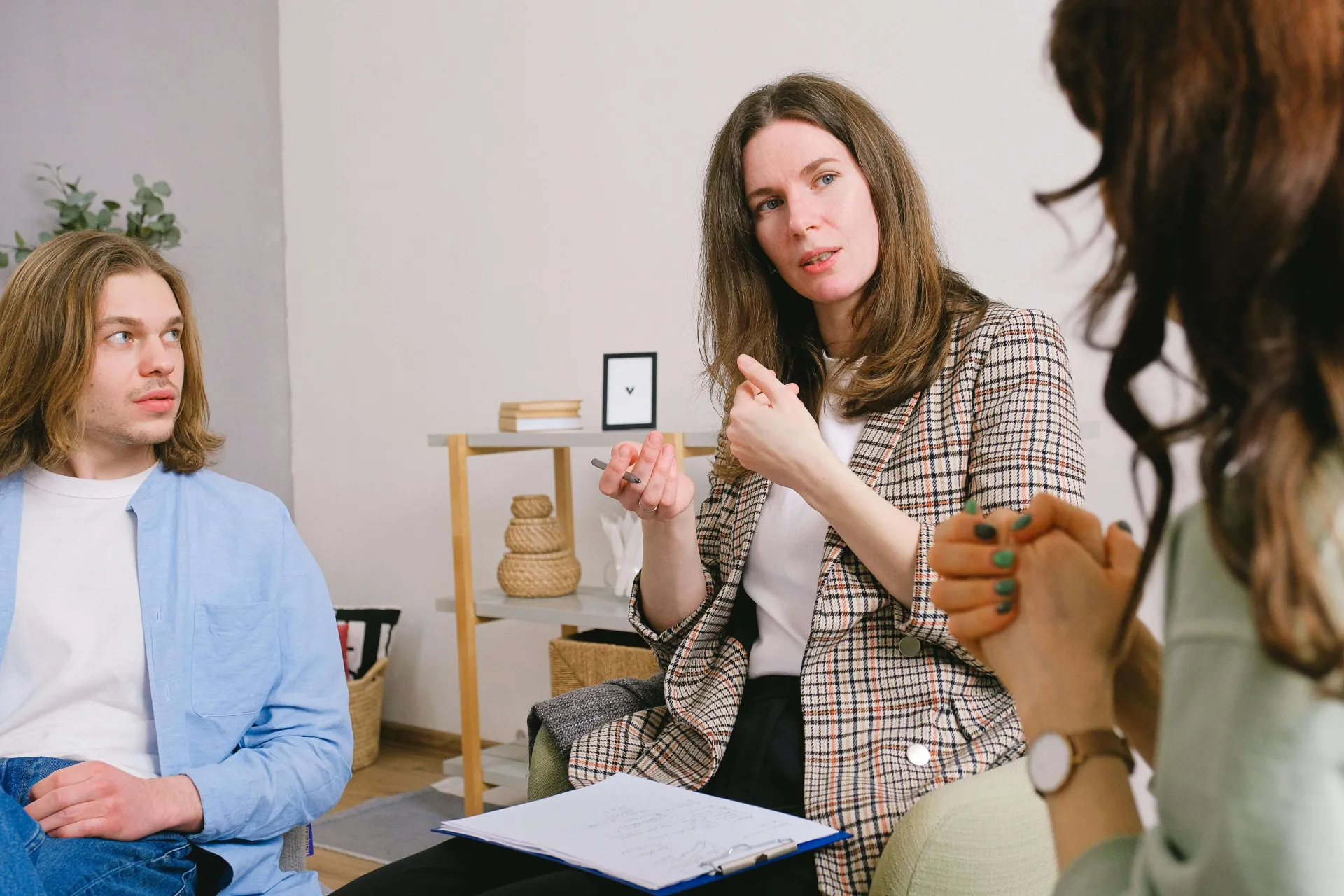A woman counsels a student and another person
