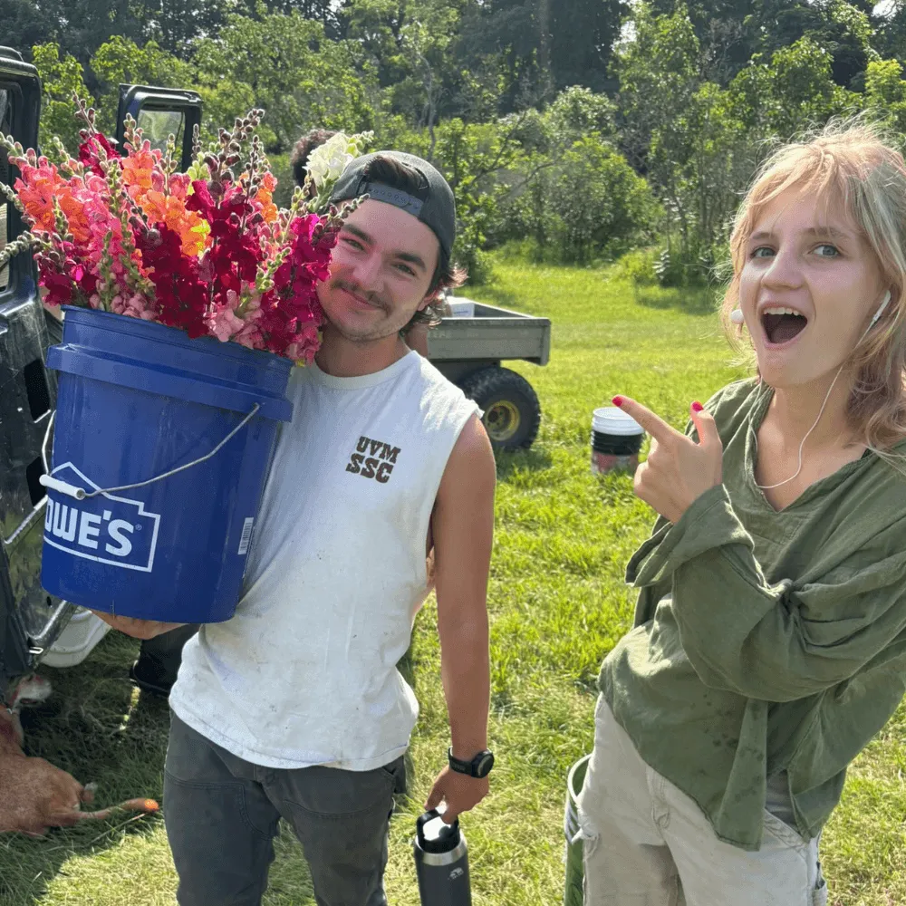 UVM Agriculture Club Students with Five Gallon Bucket of Snapdragons for Bouquets