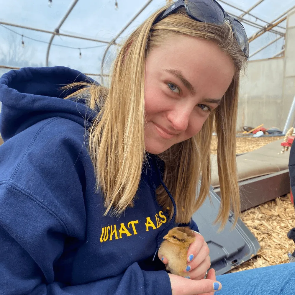 UVM student holding chick in hands