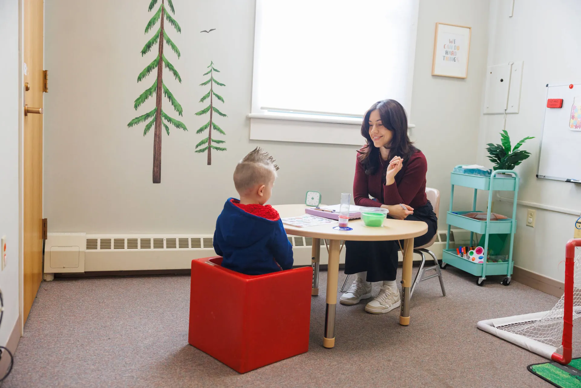Student working with a client in a SLP therapy room