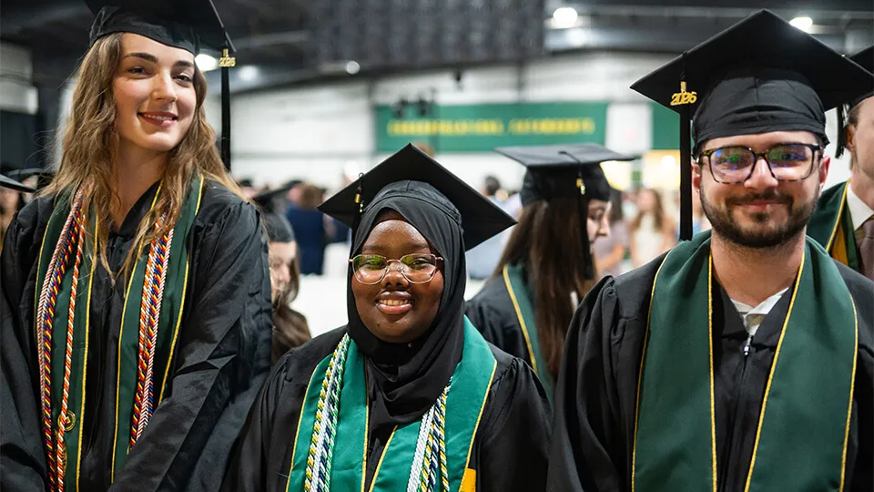 Students from the Grossman School of Business walk during the graduation ceremony at UVM