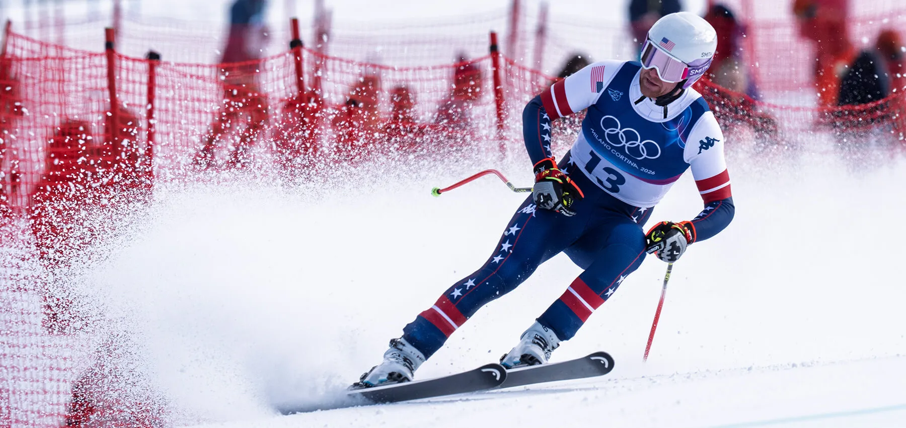 Ryan Cochran-Siegle kicks up snow as he skis around a corner