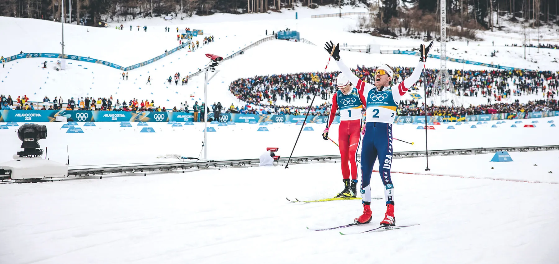 Ben Ogden and his teammate celebrate as they cross the finish line on skis