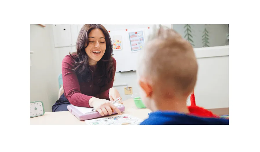 Student working with a client in a SLP therapy room