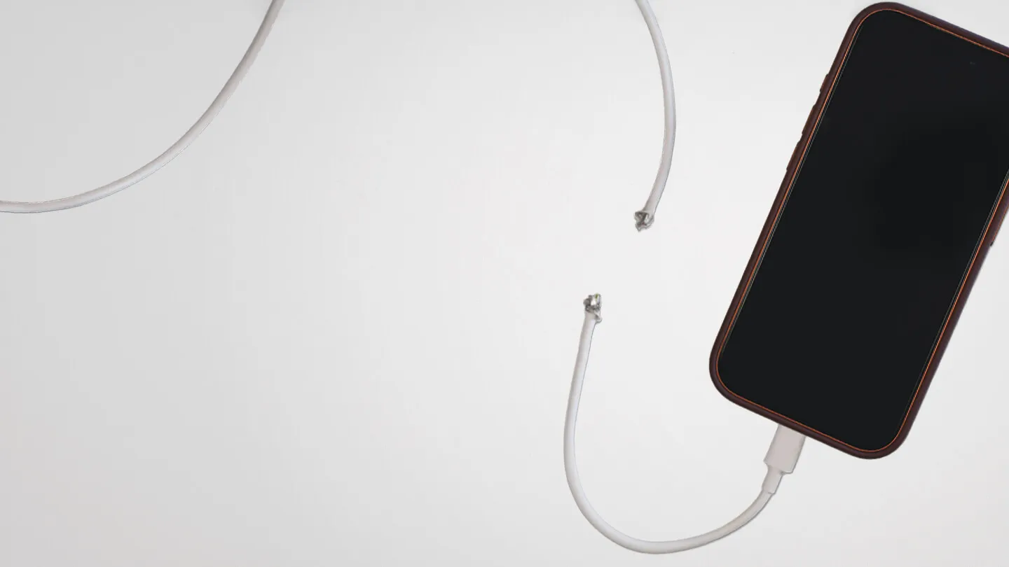 a phone connected to a cut cable against a white background