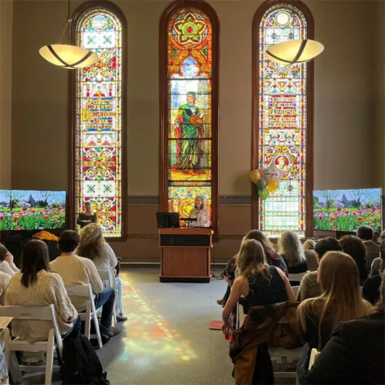 Speaker speaking to a large audience.