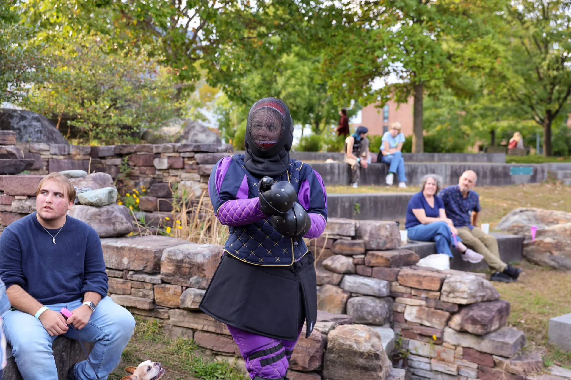 Student dressed for fencing in the outdoors