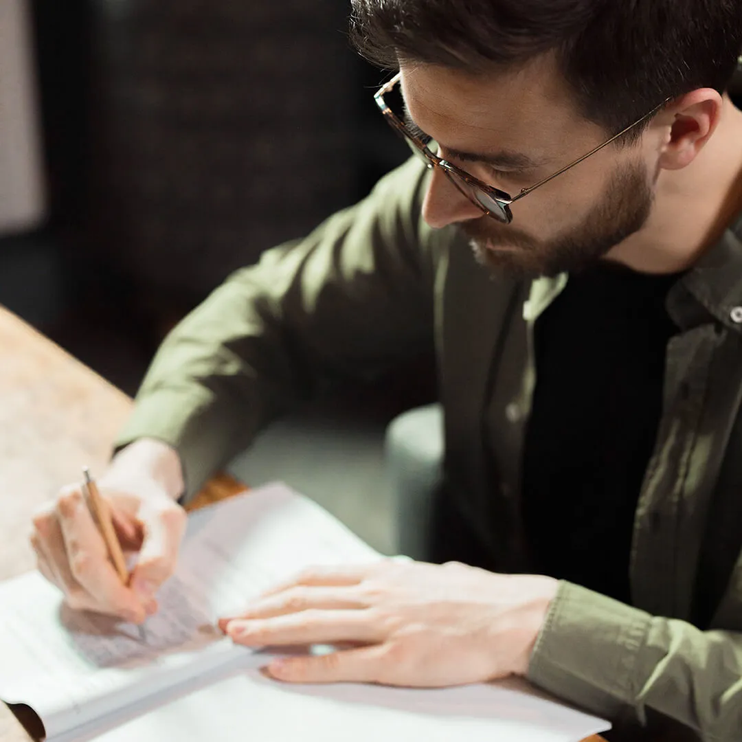 person writing in a notebook.