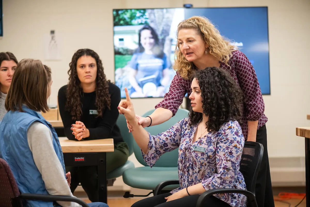 An occupational therapy student works with a faculty member