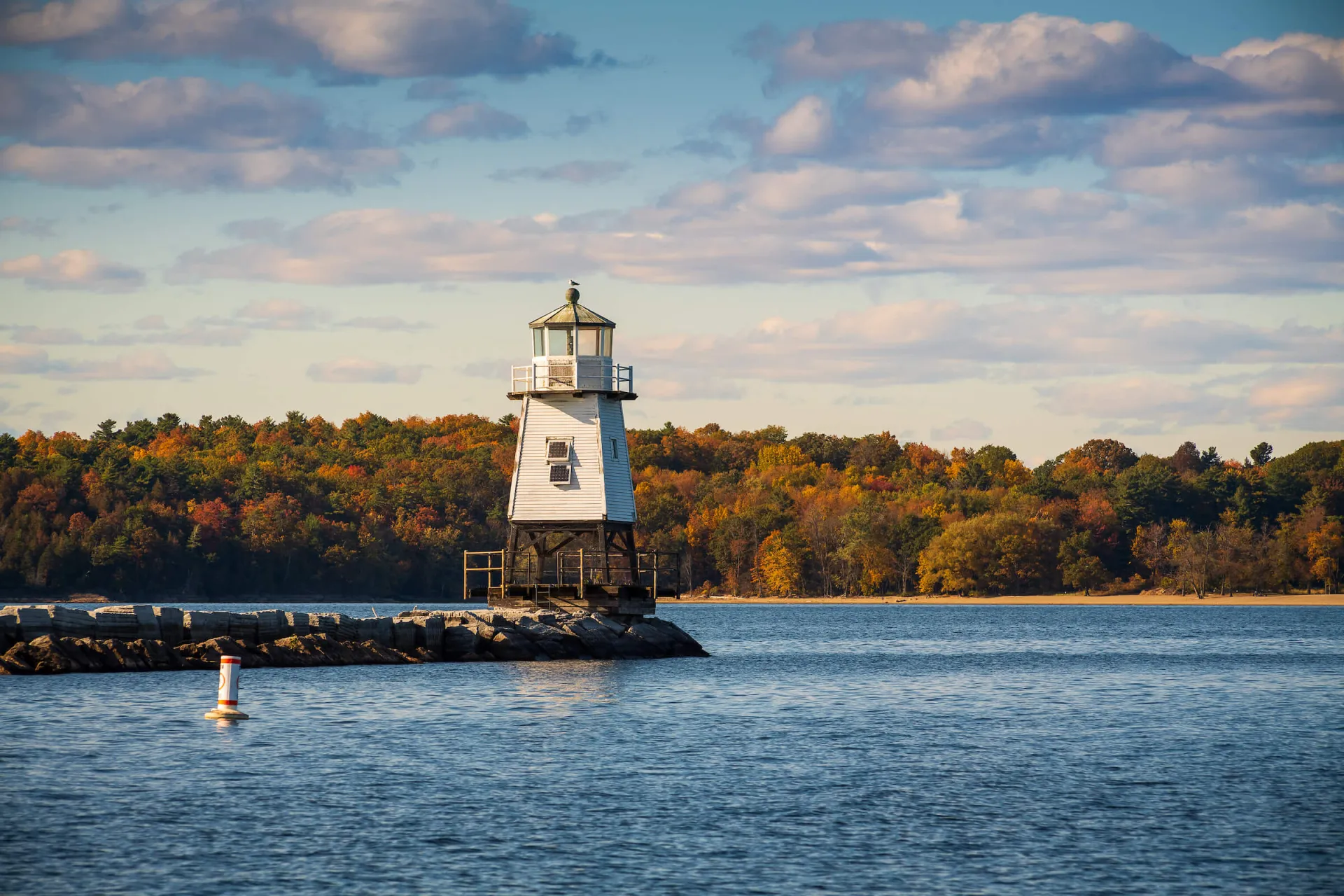Lighthouse with wave break on Lake Champlain