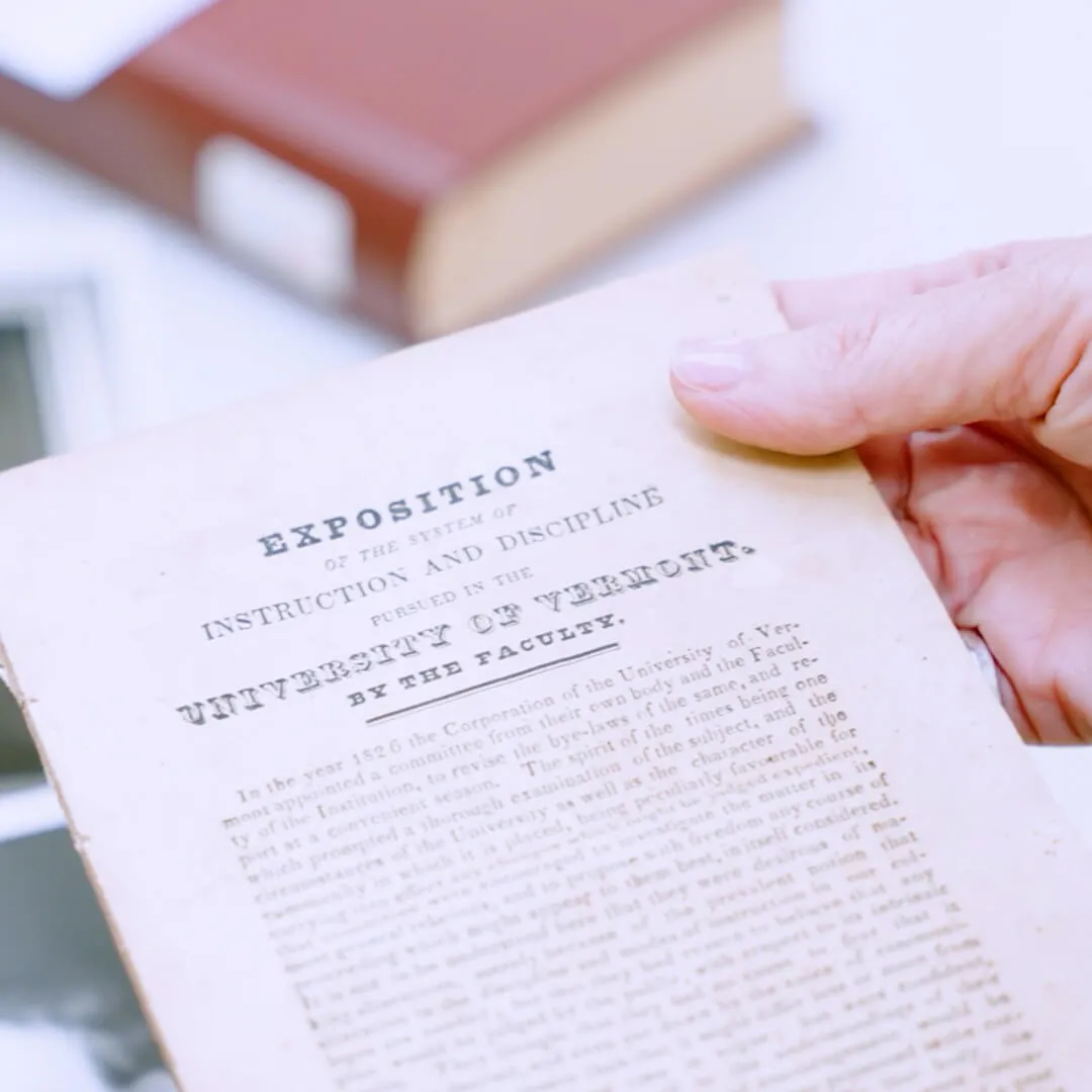 a hand holds a old piece of paper that says Exposition at the top