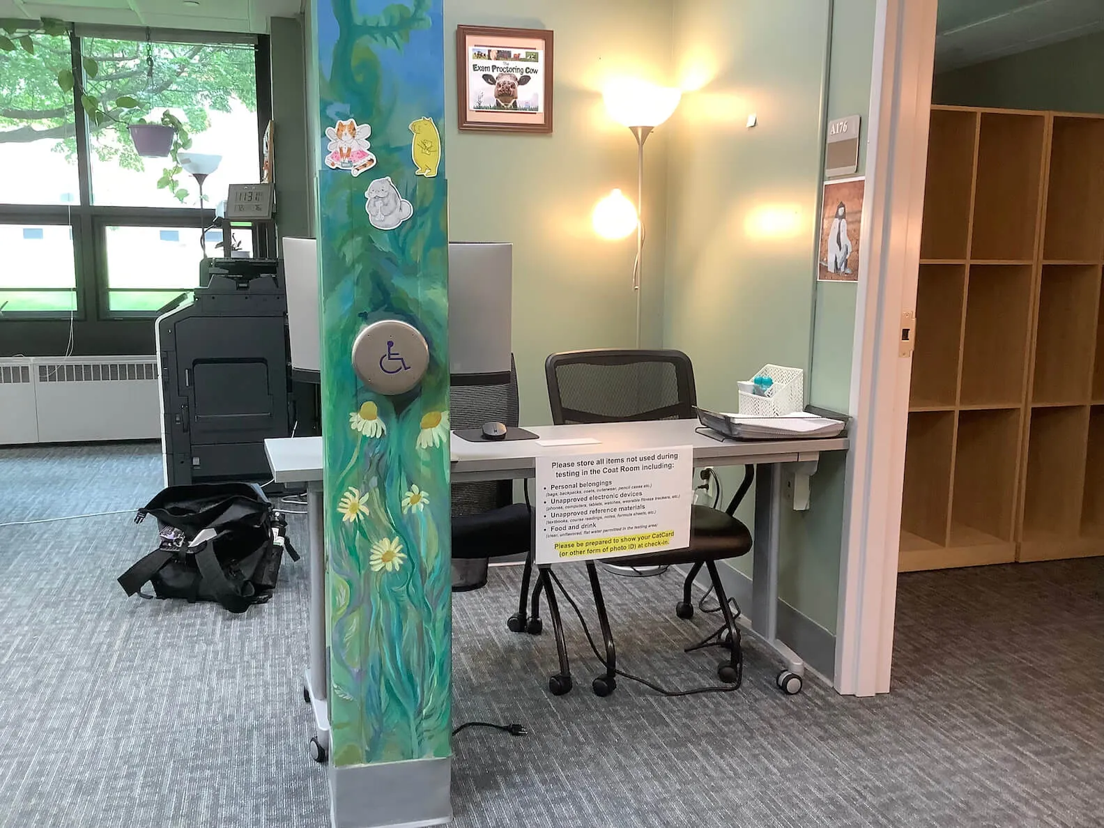 an empty check-in desk in a welcoming office, with an accessible door opener button on painted column nearby