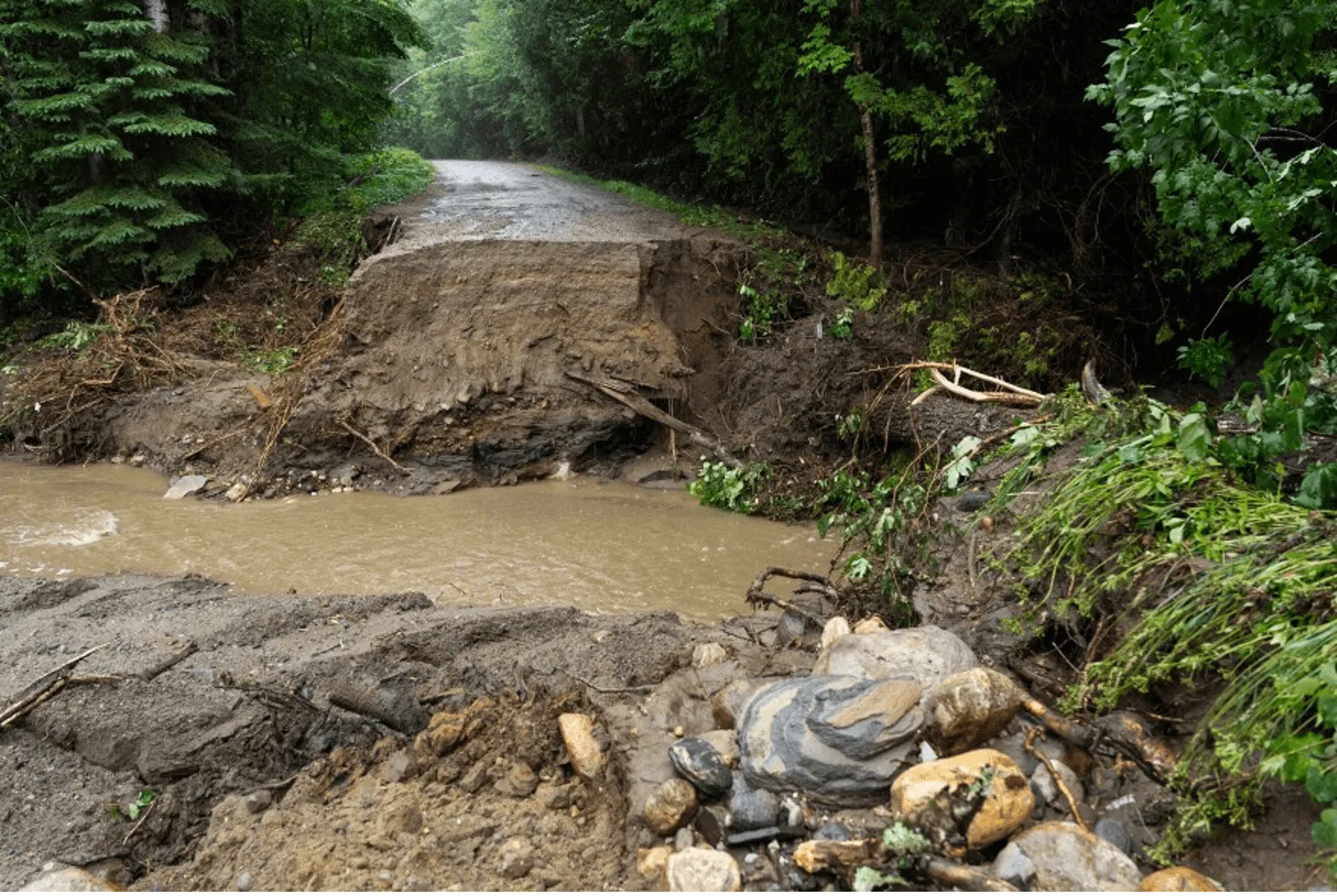 A road is washed out and impassable as a result of flash flooding.