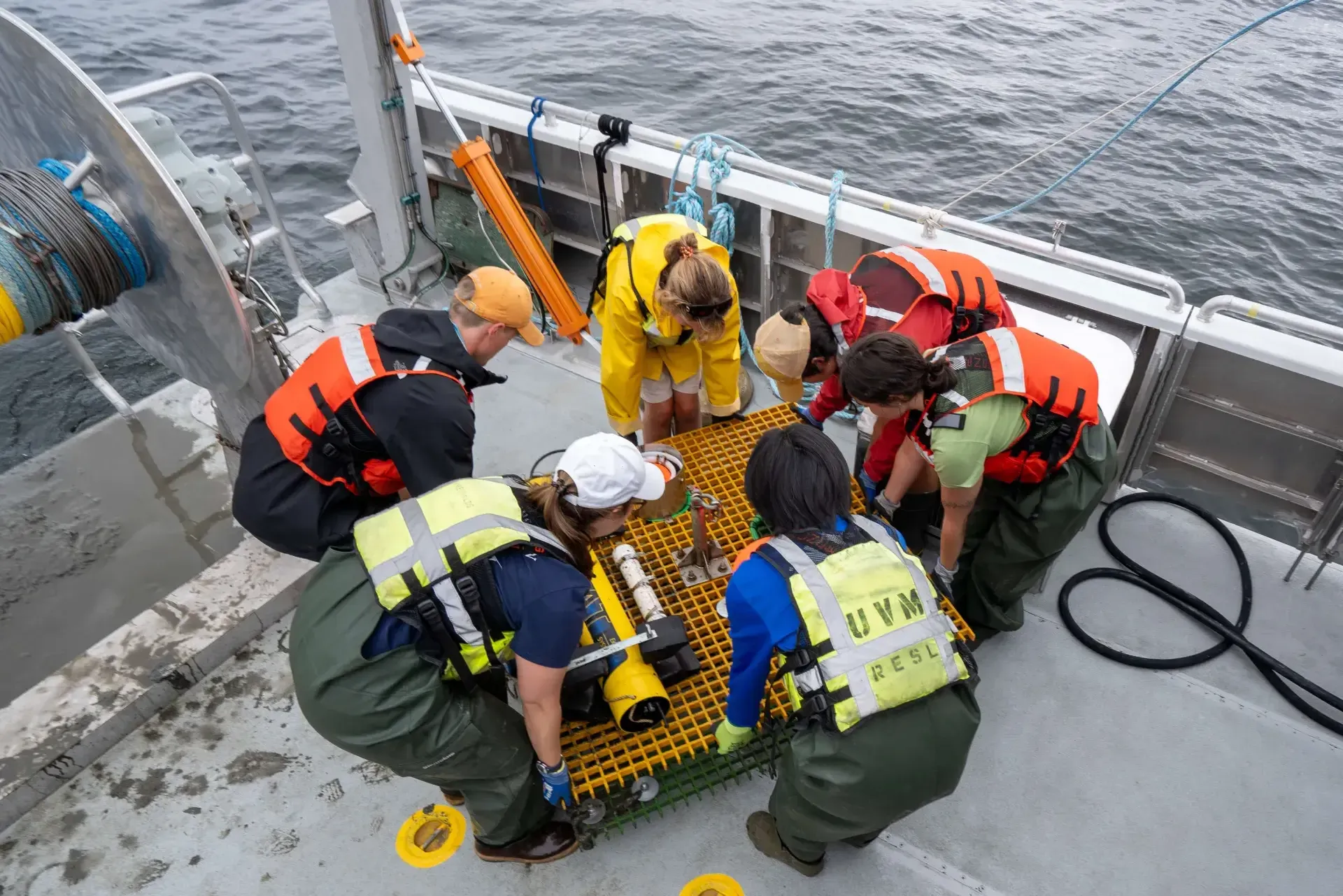 A team of researchers unload equipment on a boat