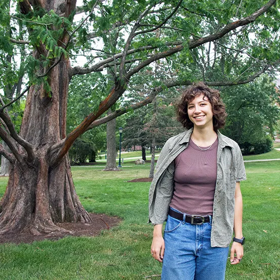Staja Szukala standing next to a large tree