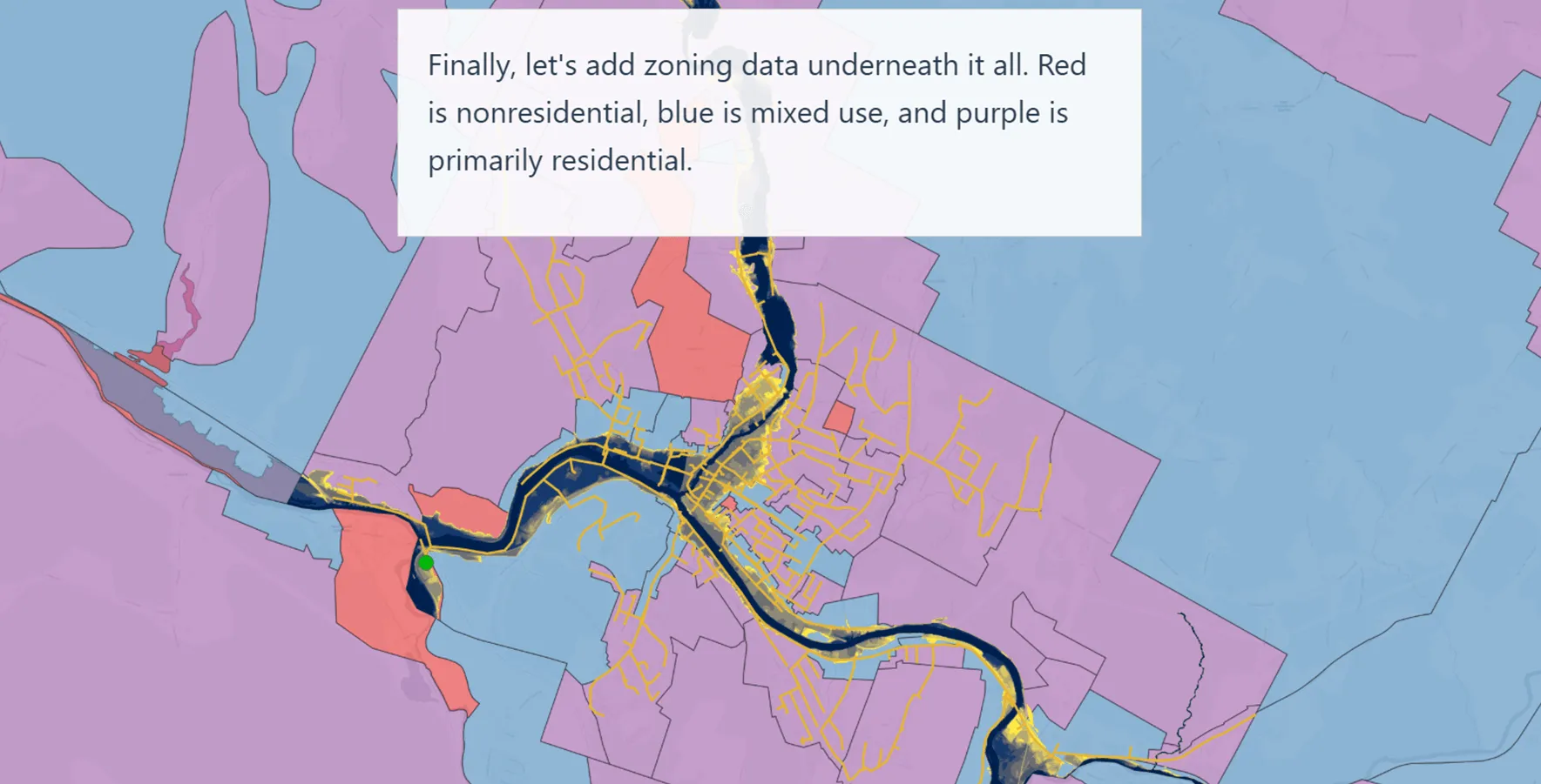 A map showing what the Vermont Livability Map materials looks like. It classifies different parcels of lad near a river. The blue is mixed use, the red non-residential and the purple is primarily residential.